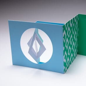 Designers use the Diamond Spinner Holiday Card to send a greeting to their clients
